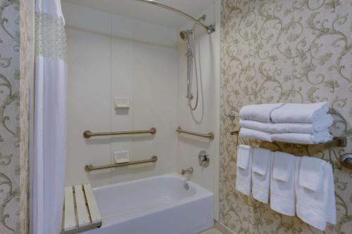 y baño con bañera, lavabo y toallas. en Hampton Inn & Suites Chincoteague-Waterfront, Va, en Chincoteague