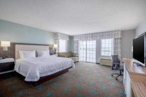 une chambre d'hôtel avec un lit et une télévision dans l'établissement Hampton Inn & Suites Chincoteague-Waterfront, Va, à Chincoteague