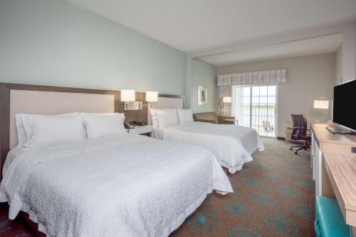 a hotel room with two beds and a television at Hampton Inn & Suites Chincoteague-Waterfront, Va in Chincoteague