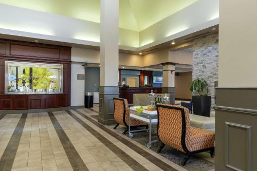 a lobby with a table and chairs and a kitchen at Hilton Garden Inn West Des Moines in West Des Moines