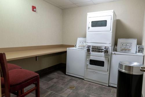 a room with appliances and a table and a chair at Hilton Garden Inn West Des Moines in West Des Moines