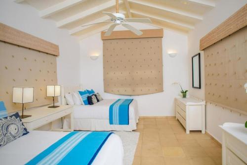 a bedroom with two beds and a ceiling fan at Sunny Vacation Villa No 93 in San Rafael del Yuma