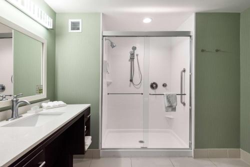 a bathroom with a shower with a glass door at Home2 Suites By Hilton Ft. Lauderdale Airport-Cruise Port in Dania Beach