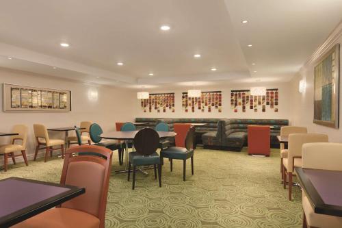 a waiting room with tables and chairs in a hotel at Homewood Suites Harrisburg-West Hershey Area in Mechanicsburg