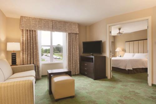 a hotel room with a bed and a television at Homewood Suites Harrisburg-West Hershey Area in Mechanicsburg