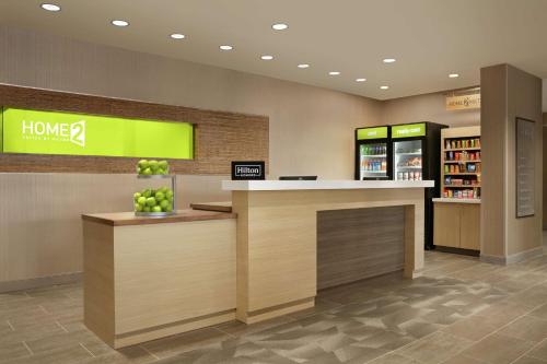 a lobby of a store with a counter with apples on it at Home2 Suites By Hilton Chantilly Dulles Airport in Chantilly