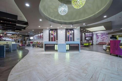 a lobby of a store with a large lobby at DoubleTree by Hilton Winston Salem - University, NC in Winston-Salem