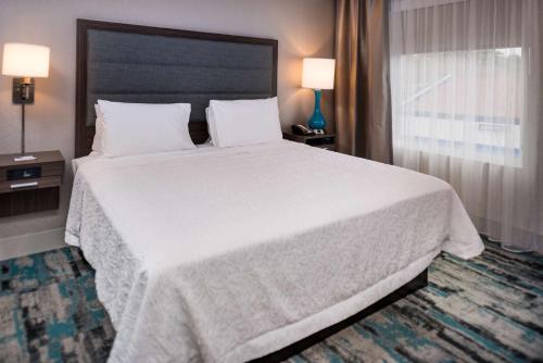 a bedroom with a large white bed with two lamps at Hampton Inn & Suites Olympia Lacey, Wa in Olympia