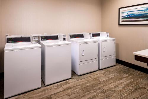 four washers and dryers are lined up in a room at Hampton Inn & Suites Olympia Lacey, Wa in Olympia