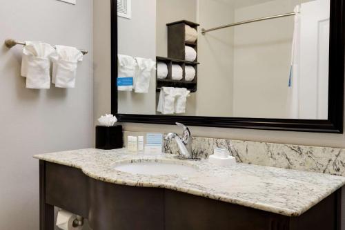 a bathroom with a sink and a mirror at Hampton Inn & Suites Temecula in Temecula