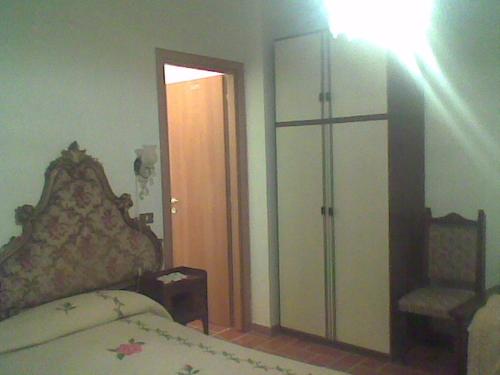 a bedroom with a bed and a closet and a door at Bed&Breakfast Giardino Agritourist in Controguerra