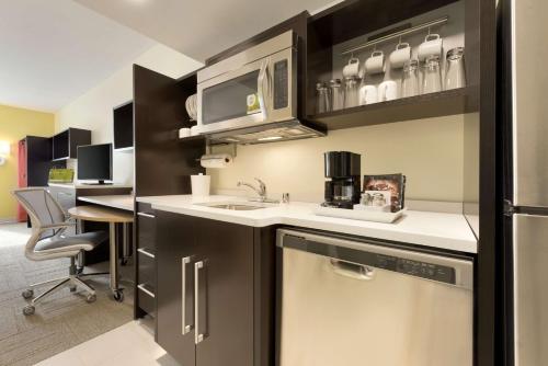 a kitchen with a sink and a dishwasher at Home2 Suites By Hilton La Crosse in La Crosse