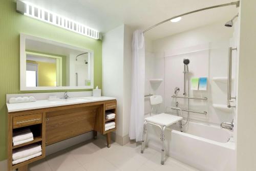 a bathroom with a sink and a tub and a shower at Home2 Suites By Hilton La Crosse in La Crosse