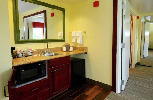 a bathroom with a sink and a mirror at Hampton Inn and Suites of Lamar in Mill Hall