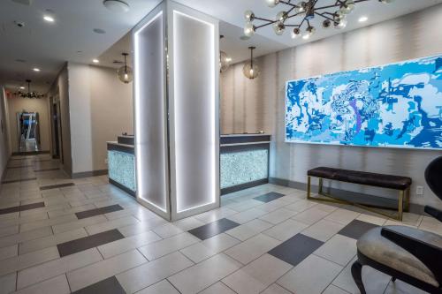a lobby with a large painting on the wall at The Bernic Hotel New York City,Tapestry Collection by Hilton in New York