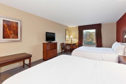 a hotel room with two beds and a flat screen tv at Hampton Inn & Suites Exmore - Eastern Shore in Exmore