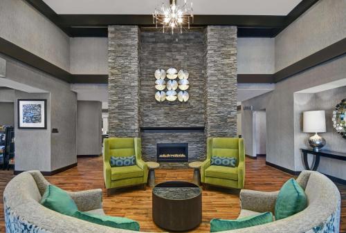 a lobby with two chairs and a fireplace at Homewood Suites - Doylestown in Warrington
