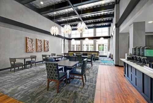a dining room with tables and chairs and windows at Homewood Suites - Doylestown in Warrington