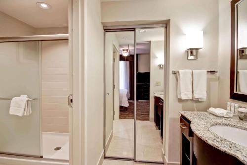 a bathroom with a walk in shower and a sink at Homewood Suites - Doylestown in Warrington