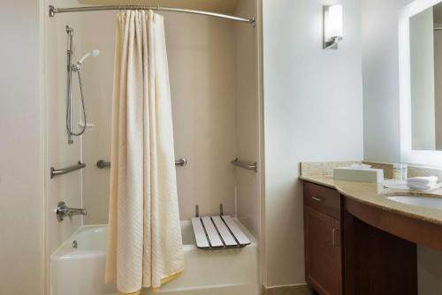 a bathroom with a shower with a shower curtain at Homewood Suites by Hilton Princeton in Princeton