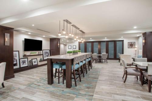 a dining room with a large table and chairs at Hampton Inn Rochester Penfield, Ny in Penfield