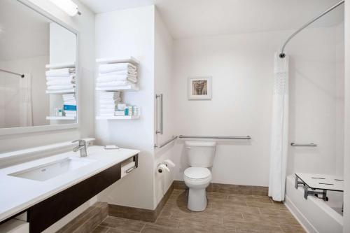 a white bathroom with a sink and a toilet at Hampton Inn Rochester Penfield, Ny in Penfield