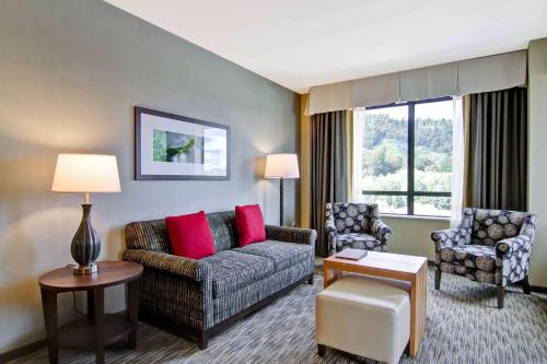 a living room with a couch and two chairs at Homewood Suites by Hilton Seattle-Issaquah in Issaquah