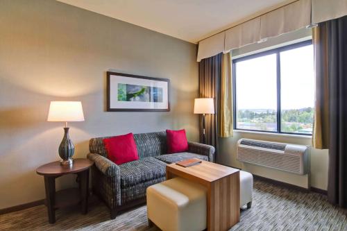a living room with a couch and a window at Homewood Suites by Hilton Seattle-Issaquah in Issaquah