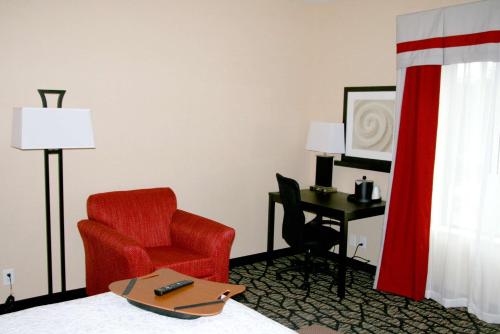 a hotel room with a red chair and a desk at Hampton Inn & Suites Salt Lake City-University/Foothill Drive in Salt Lake City