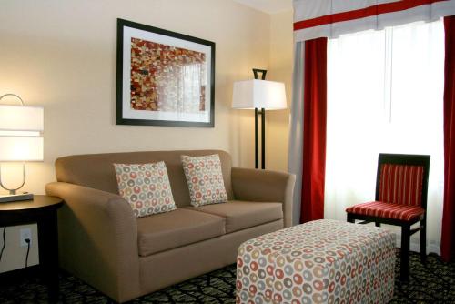 a hotel room with a couch and a chair at Hampton Inn & Suites Salt Lake City-University/Foothill Drive in Salt Lake City