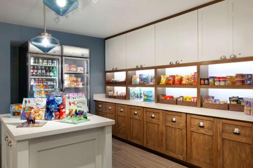 a store with wooden cabinets and a counter in a room at Homewood Suites By Hilton Irvine John Wayne Airport in Irvine