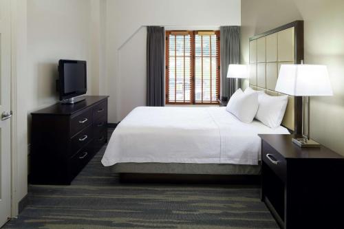 a hotel room with a bed and a television at Homewood Suites by Hilton Mont-Tremblant Resort in Mont-Tremblant