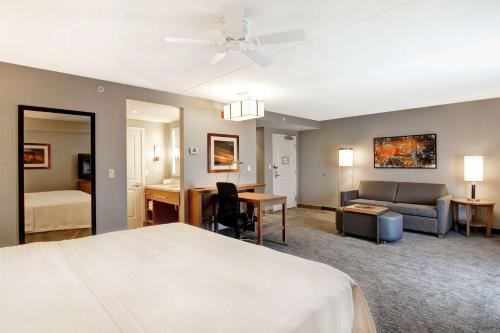 a hotel room with a bed and a couch at Homewood Suites By Hilton Ottawa Kanata in Ottawa