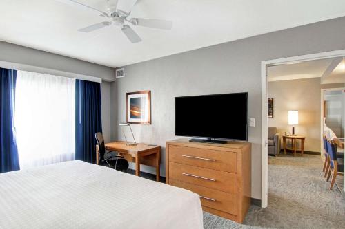 a hotel room with a bed and a flat screen tv at Homewood Suites By Hilton Ottawa Kanata in Ottawa