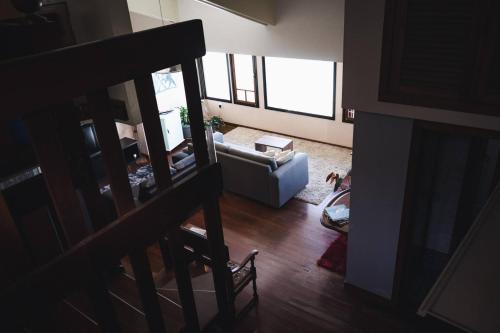 a living room with a couch and a chair at Hostel Jardim das Bruxas 410 in Florianópolis