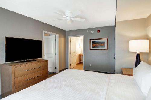 a bedroom with a bed and a flat screen tv at Homewood Suites By Hilton Ottawa Kanata in Ottawa