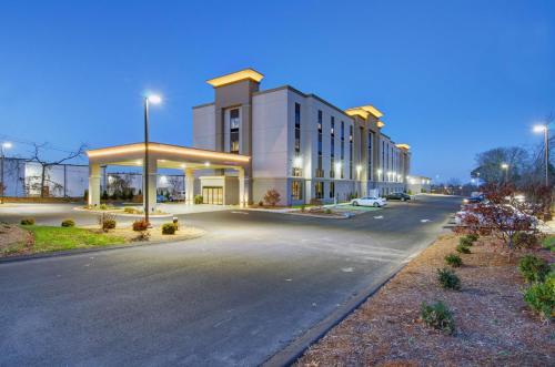a building with a gas station on a street at Hampton Inn & Suites Boston/Stoughton, Ma in Stoughton