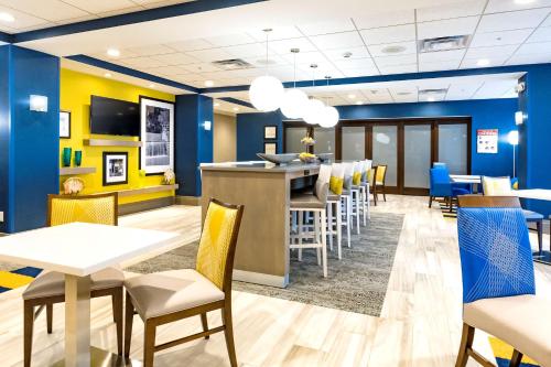 a restaurant with blue walls and tables and chairs at Hampton Inn Lockport - Buffalo, NY in Lockport