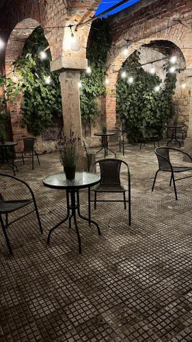 a patio with tables and chairs in a building at Pałac Lasów in Pieńsk