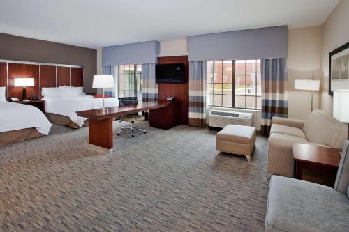 a hotel room with a bed and a desk at Hampton Inn & Suites Chapel Hill/Carrboro in Chapel Hill
