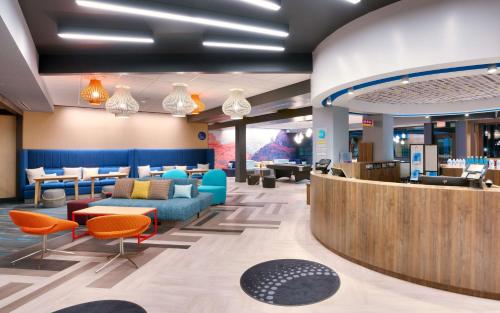 a lobby of a store with colorful chairs and tables at Tru By Hilton St. George in St. George