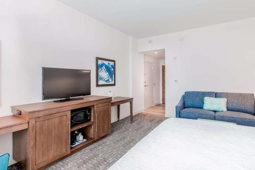 a living room with a flat screen tv and a couch at Hampton Inn & Suites Panama City Beach-Beachfront in Panama City Beach
