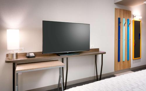 a flat screen tv sitting on a table in a room at Tru By Hilton St. George in St. George