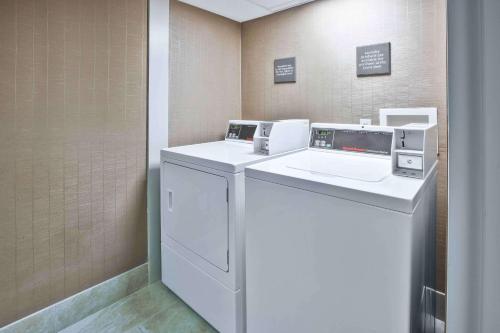 a laundry room with a washer and a dryer at Hampton Inn Toledo-South/Maumee in Maumee