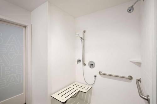 a white bathroom with a bench in it at Hampton Inn Salt Lake City Cottonwood in Holladay