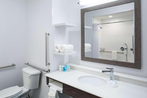 a bathroom with a toilet and a sink with a mirror at Hampton Inn Atlantic City/Absecon, NJ in Absecon