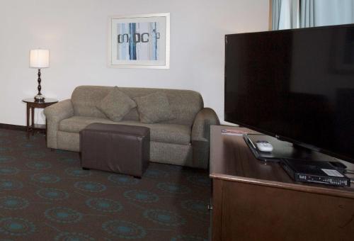 a living room with a couch and a flat screen tv at Hampton Inn & Suites Suisun City Waterfront in Suisun City