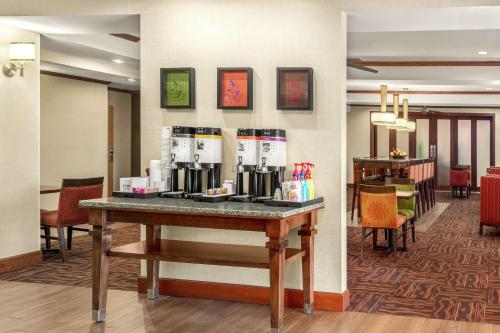 a lobby with a table with coffee makers on it at Hampton Inn Athens in Athens