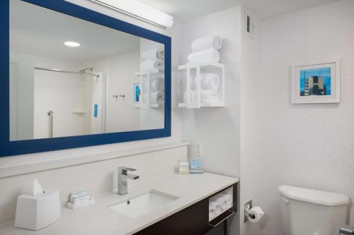 a bathroom with a sink and a mirror at Hampton Inn Bartlesville in Bartlesville