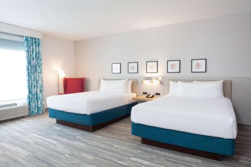 a hotel room with two beds and a window at Hilton Garden Inn Broomfield Boulder in Broomfield